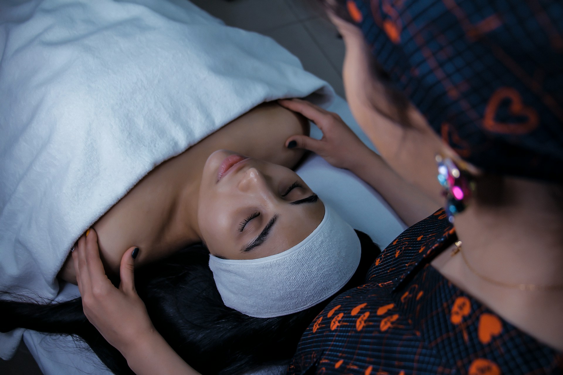 A woman lying down on a treatment bed getting ready for Profhilo Skin Booster and Polynucleotides treatment